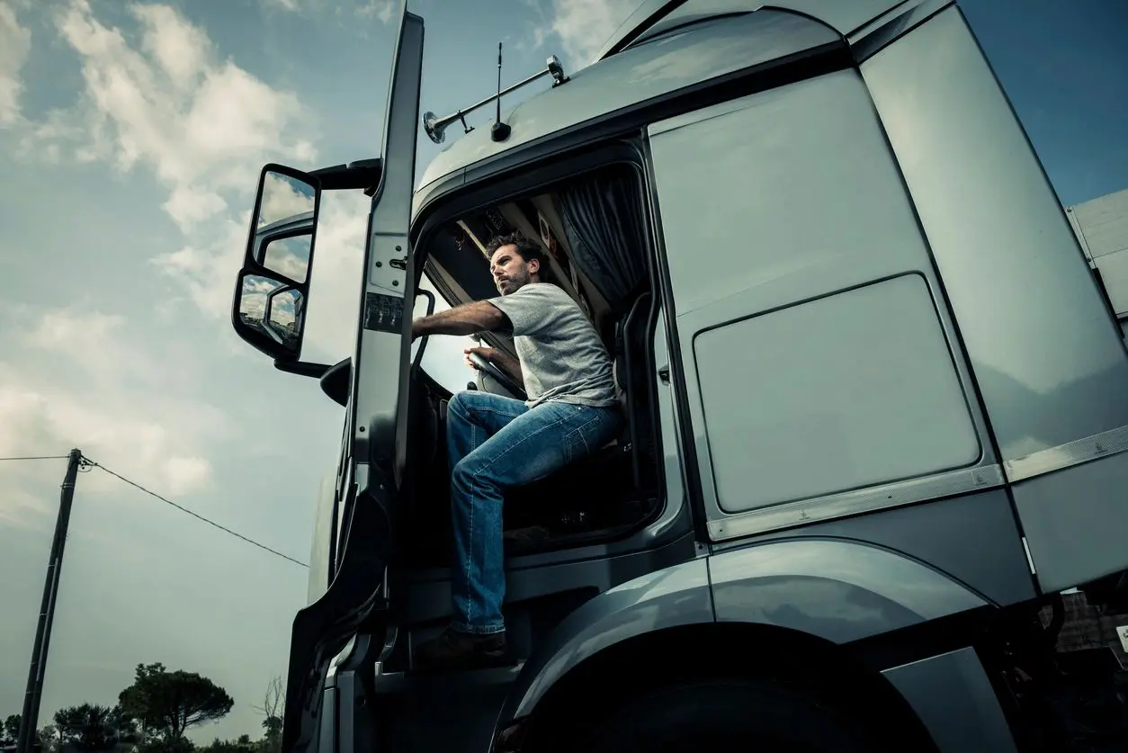 A man getting on the driver’s seat of a truck